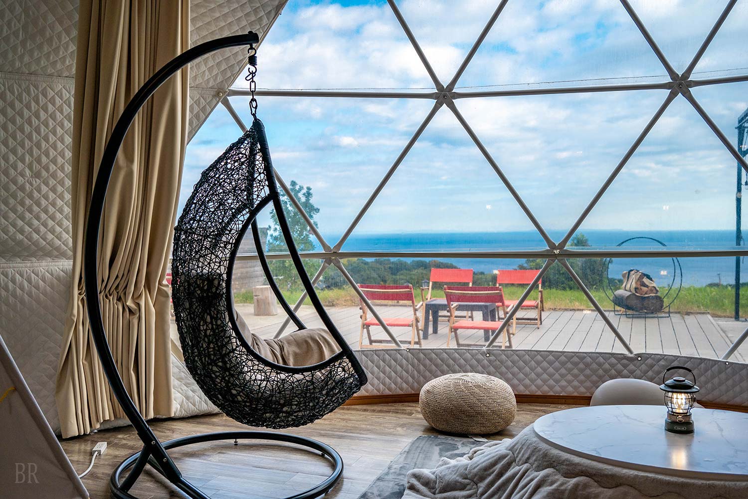 Ocean view through the window of a dome tent at Glam Aira Izu-kogen